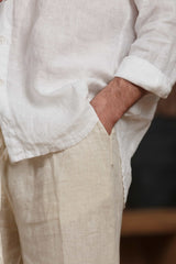 Close-up of the white linen shirt and beige linen trousers, capturing the texture of the natural fabric and the relaxed cut. Ideal for summer wear in Dubai, UAE, and GCC, offering breathability and comfort in hot climates.