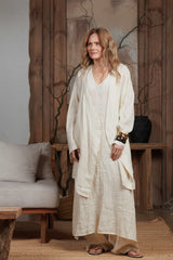 Side view of the beige linen kimono, emphasizing its minimalist silhouette and flowing design. Crafted from premium linen, this kimono is ideal for effortless style during beach vacations or casual outings in the GCC region.