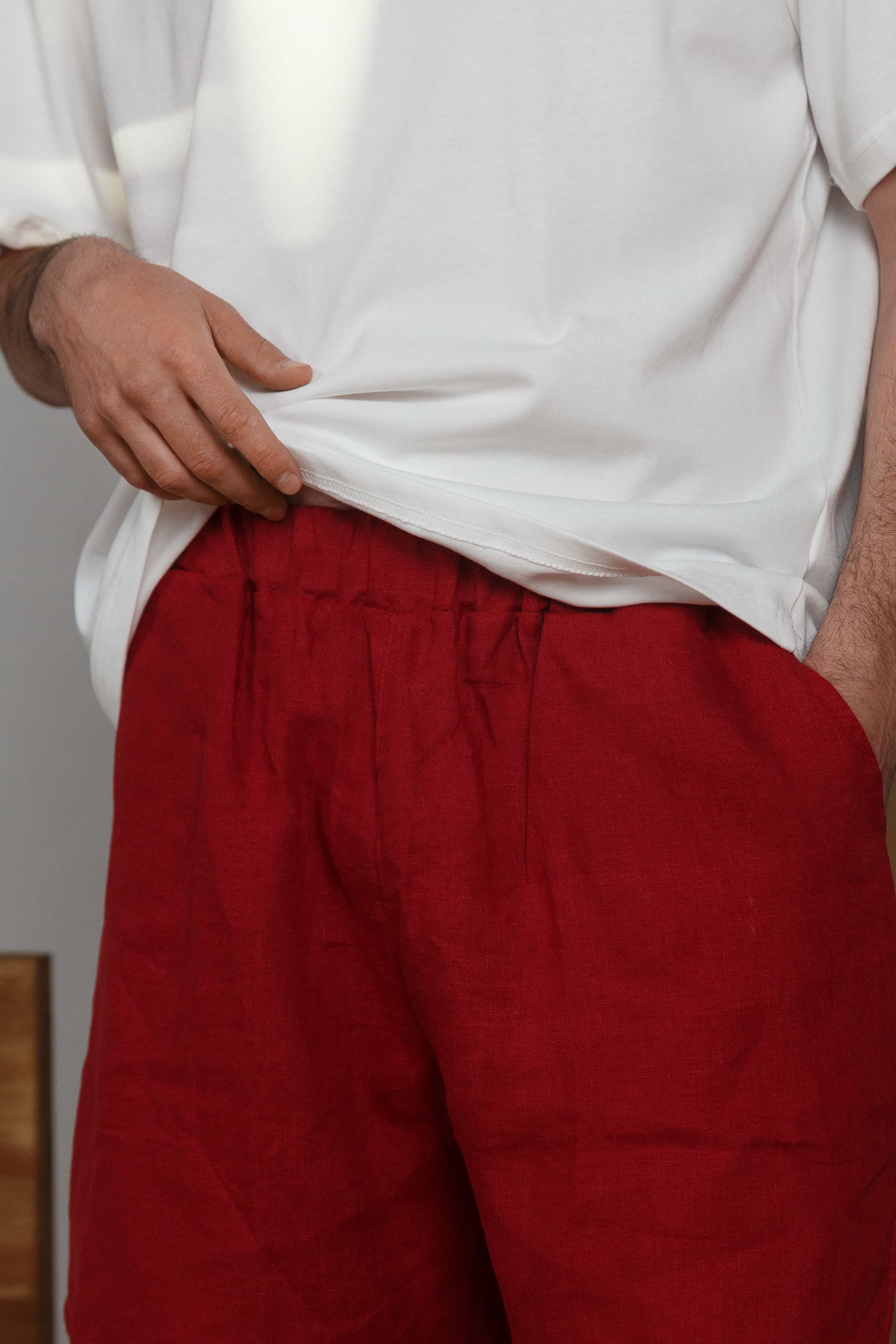 Detailed close-up of men's red linen shorts, showcasing the soft, breathable linen fabric and elastic waistband. Perfect for summer wear in Dubai and GCC, reflecting comfort and style in warm climates.